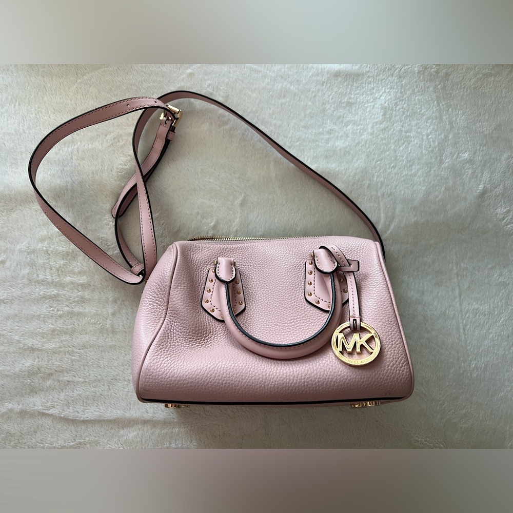 Michael Kors handbag with crossbody strap. Light pink color with gold metal.